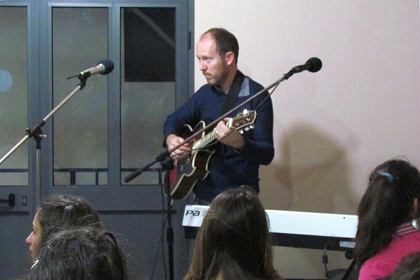 Robert Cook tuning up a guitar for worship on Easter morning